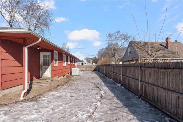 exterior space featuring fence and cooling unit