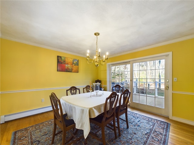 dining area featuring hardwood / wood-style floors, ornamental molding, and baseboard heating