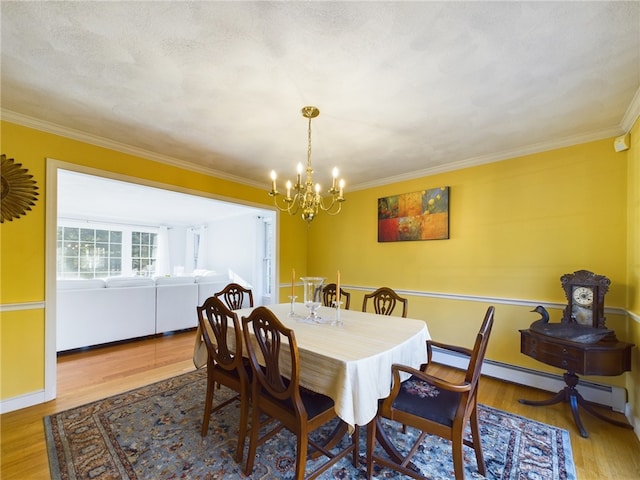 dining room featuring a baseboard radiator, ornamental molding, and hardwood / wood-style floors