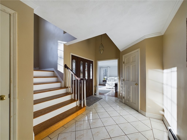 entryway with light tile patterned floors, crown molding, vaulted ceiling, and baseboard heating