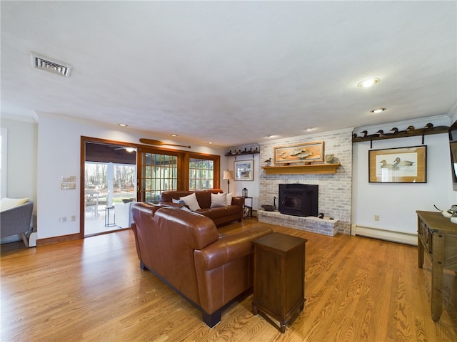 living room featuring crown molding, a baseboard radiator, and light hardwood / wood-style flooring