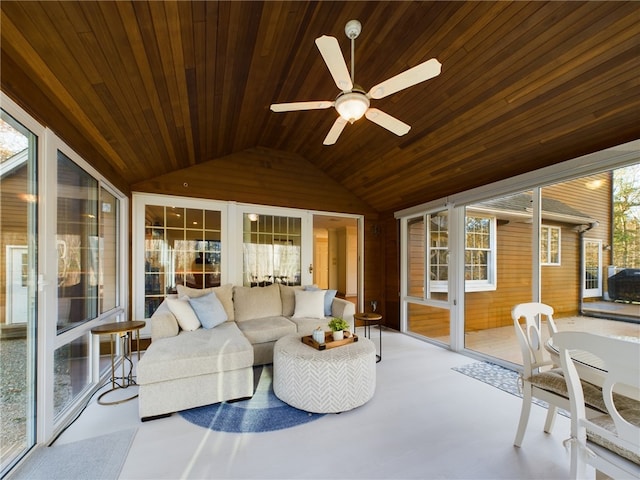 sunroom / solarium with vaulted ceiling, wooden ceiling, and ceiling fan