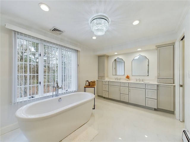 bathroom with a bathing tub, ornamental molding, vanity, a baseboard heating unit, and an inviting chandelier