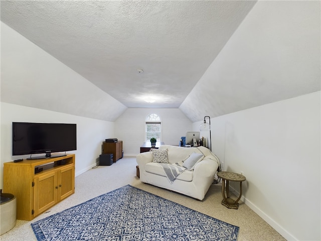 living room featuring lofted ceiling, light carpet, and a textured ceiling