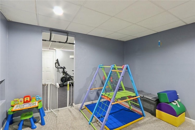 recreation room with carpet flooring and a drop ceiling