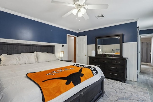 bedroom featuring crown molding, ceiling fan, and light hardwood / wood-style floors