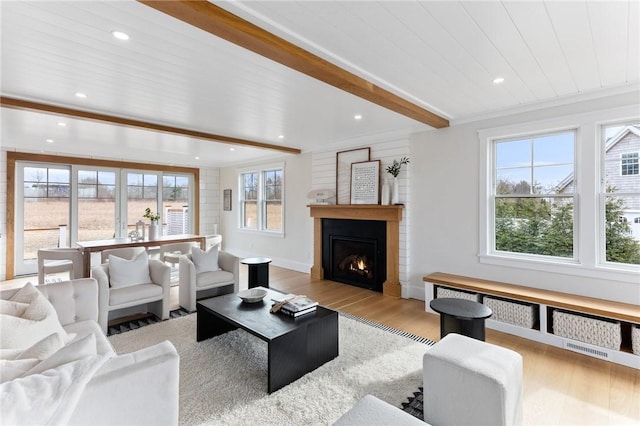 living room with beam ceiling and light wood-type flooring