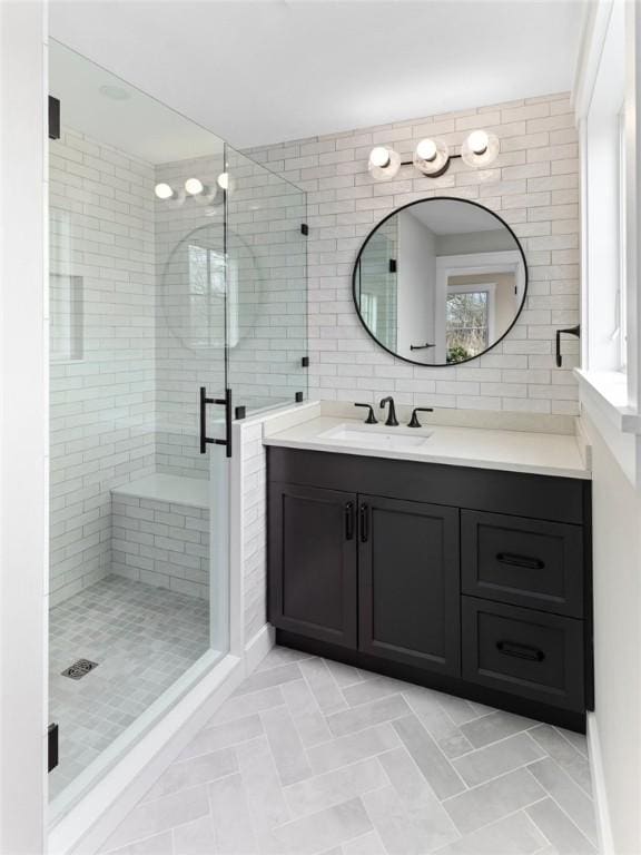 bathroom with vanity, an enclosed shower, and backsplash