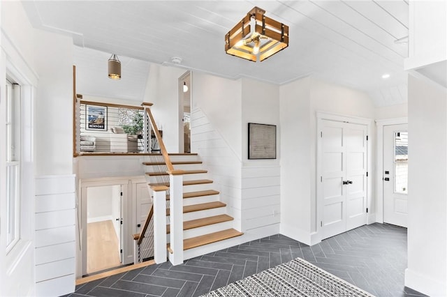 foyer entrance with lofted ceiling and dark parquet floors