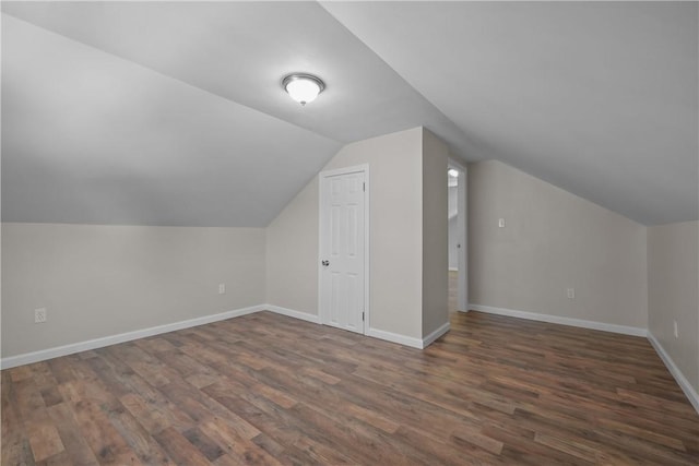 additional living space with lofted ceiling and dark hardwood / wood-style flooring