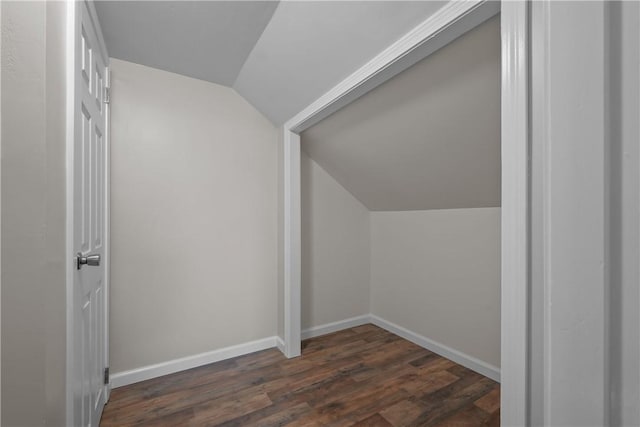 bonus room with dark hardwood / wood-style floors and vaulted ceiling