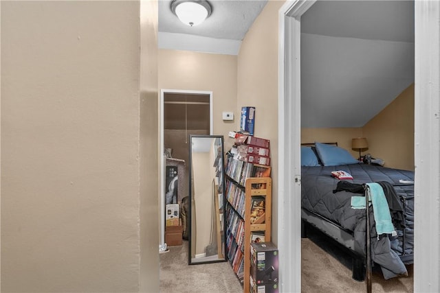 bedroom featuring vaulted ceiling and light carpet