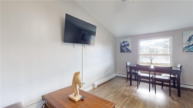 dining room featuring vaulted ceiling and hardwood / wood-style floors