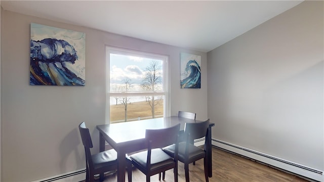 dining space featuring a baseboard radiator and hardwood / wood-style floors