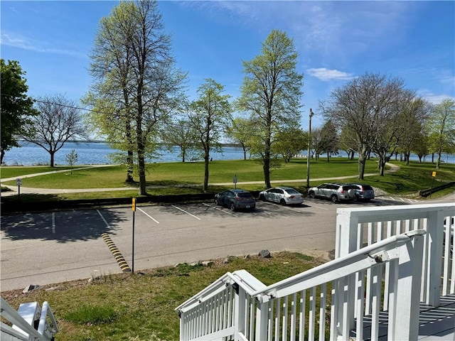 uncovered parking lot with a water view