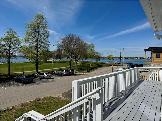 wooden terrace featuring a water view
