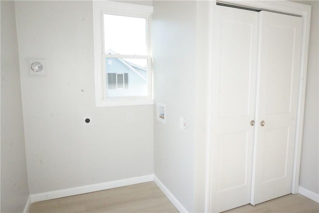 clothes washing area featuring electric dryer hookup, hookup for a washing machine, and light hardwood / wood-style floors