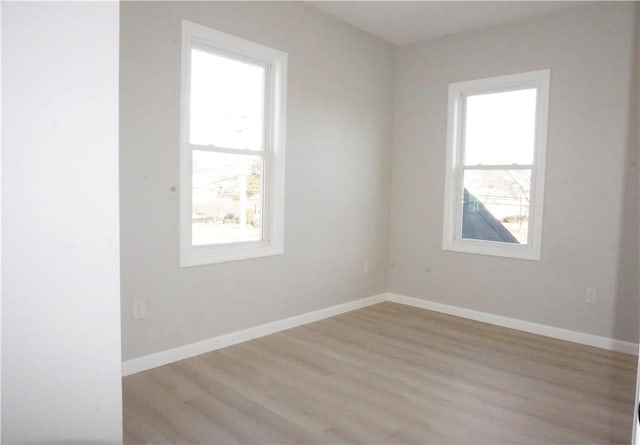 empty room featuring a healthy amount of sunlight and light wood-type flooring