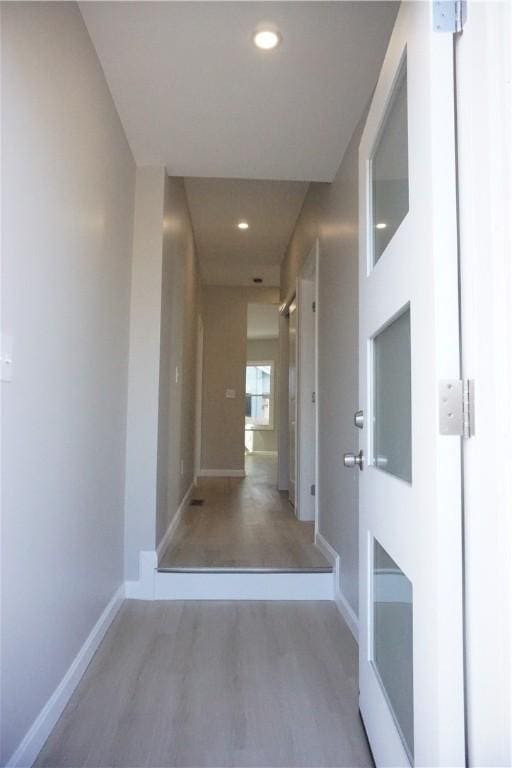 corridor with wood-type flooring