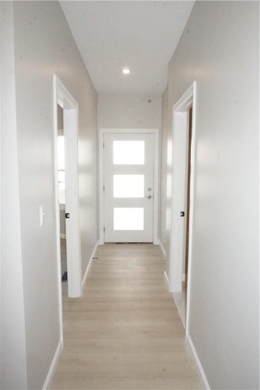 hallway with light hardwood / wood-style floors