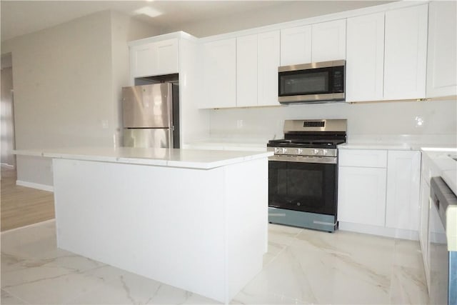 kitchen featuring white cabinetry, stainless steel appliances, and a kitchen island