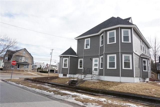 view of front of house with roof with shingles and a residential view