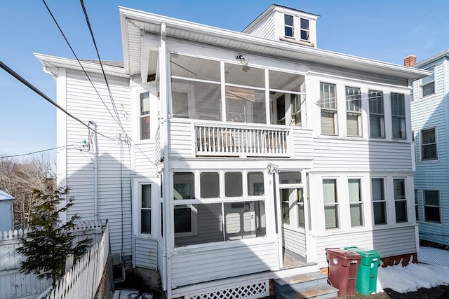 back of property with a sunroom