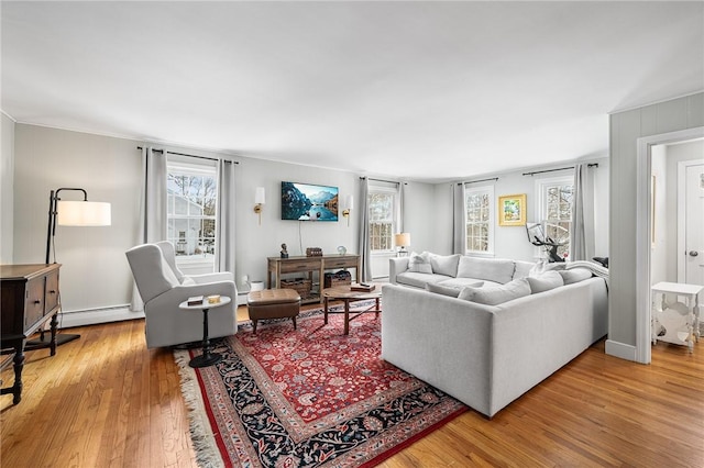 living room with light hardwood / wood-style floors and baseboard heating