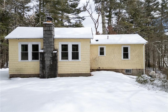 view of snow covered back of property