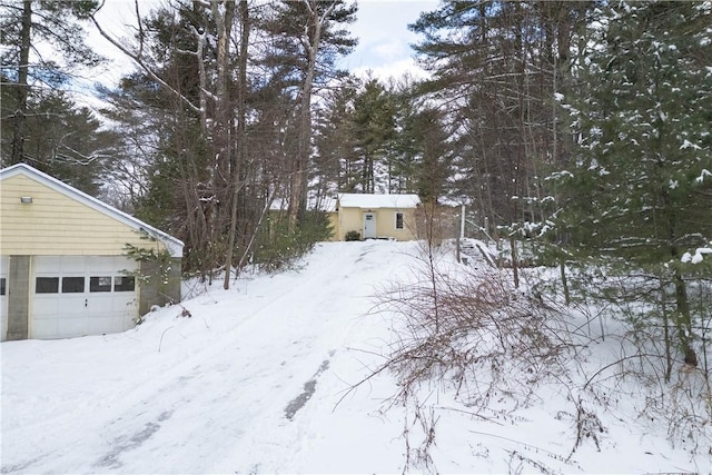 view of front of home featuring a garage and an outbuilding