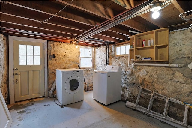 clothes washing area featuring washer and clothes dryer