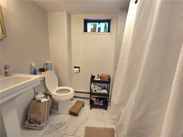 bathroom featuring a baseboard radiator and toilet