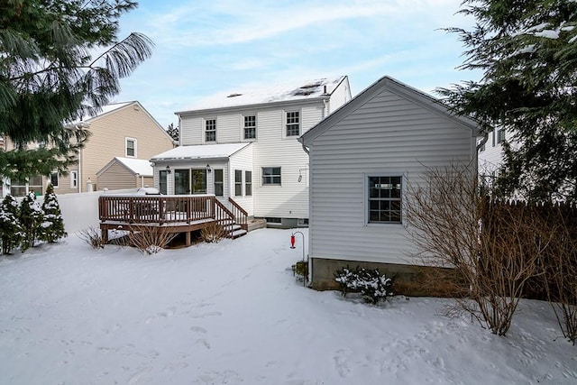 snow covered property with a deck