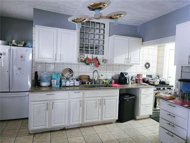36 Utton Ave, Pawtucket, RI 02860 - kitchen with freestanding refrigerator, a sink, white cabinets, light tile patterned flooring, and a textured ceiling