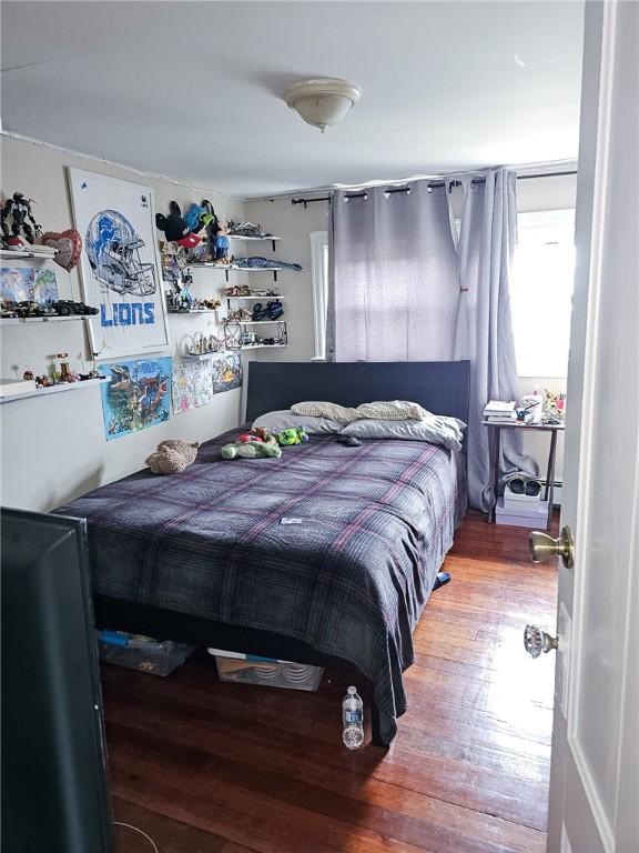 bedroom with hardwood / wood-style flooring