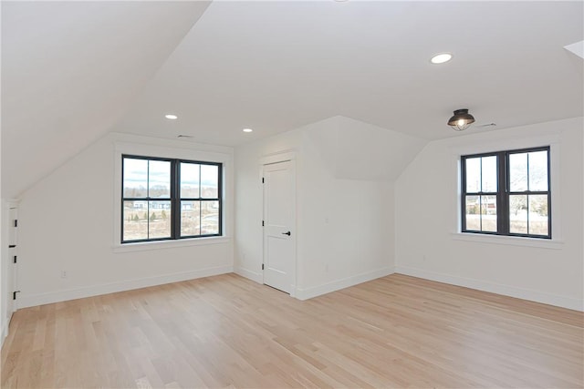 additional living space with lofted ceiling and light hardwood / wood-style floors