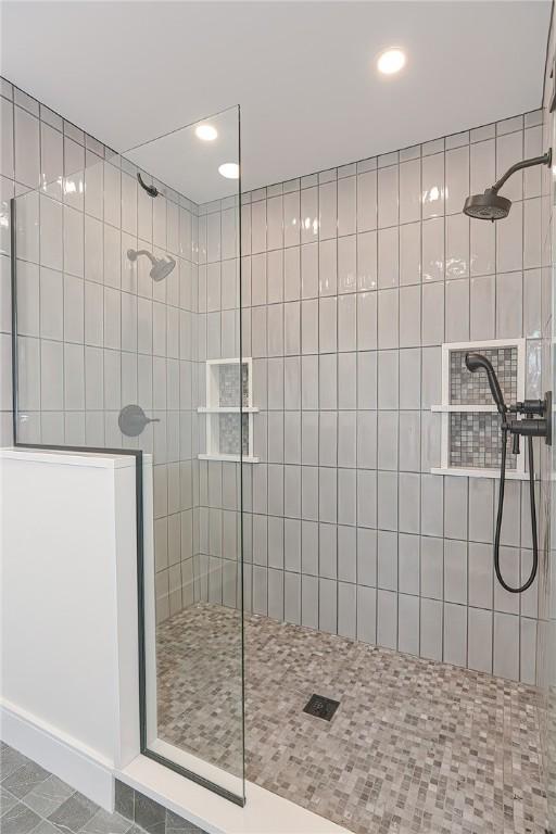 bathroom featuring a tile shower and tile patterned floors