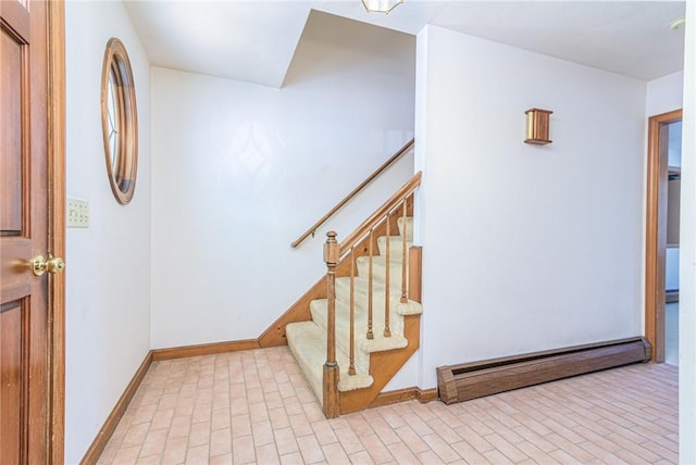 foyer entrance featuring baseboard heating