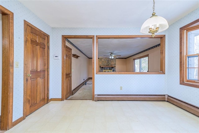 empty room with a healthy amount of sunlight and baseboard heating