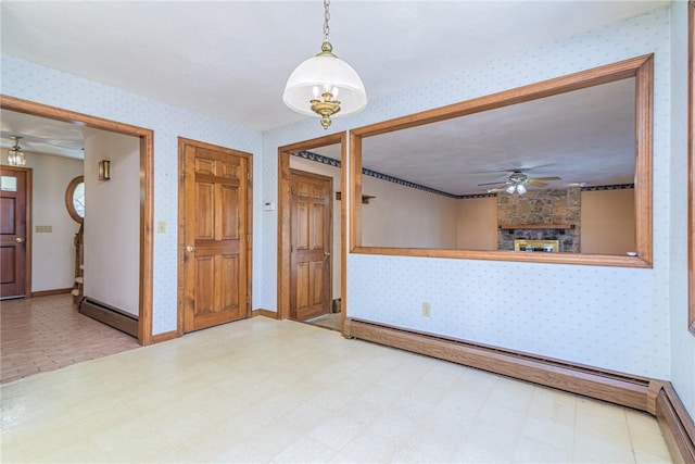 interior space with a fireplace, a baseboard radiator, and ceiling fan