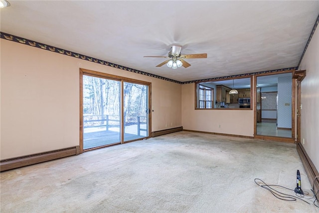 unfurnished living room with ceiling fan, baseboard heating, and carpet flooring