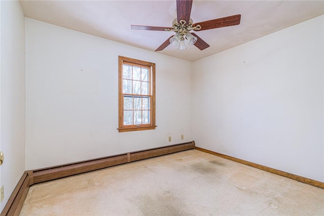 unfurnished room with carpet floors, a baseboard heating unit, and ceiling fan