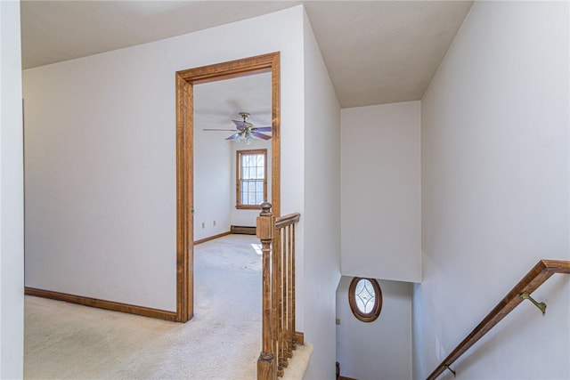 staircase featuring a baseboard radiator and carpet