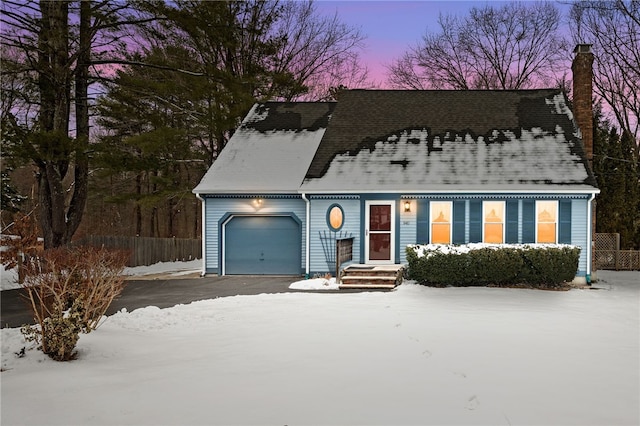 cape cod house featuring a garage