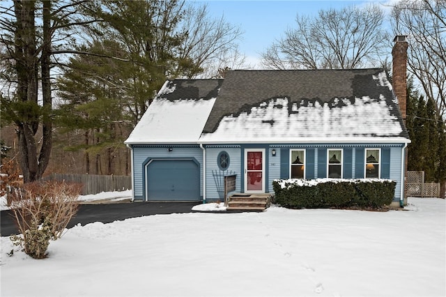 cape cod house featuring a garage