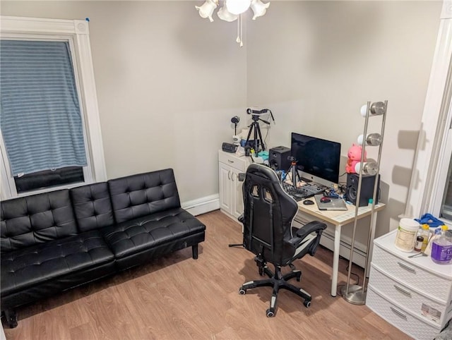 office area with baseboards and wood finished floors