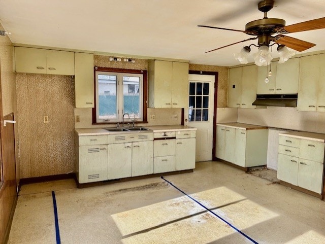 kitchen with ceiling fan, sink, and cream cabinetry