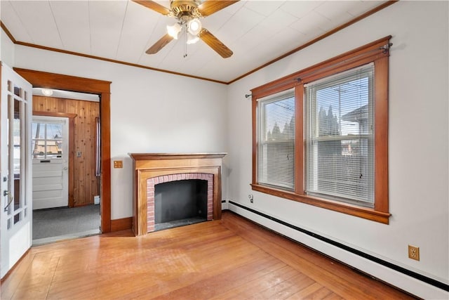 unfurnished living room featuring crown molding, a fireplace, a healthy amount of sunlight, and baseboard heating