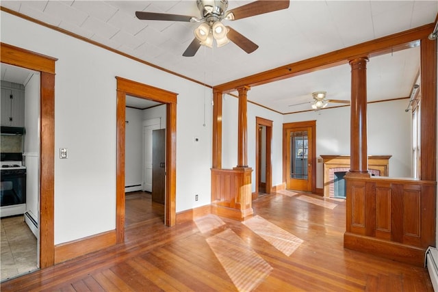 unfurnished living room featuring hardwood / wood-style flooring, ornamental molding, and decorative columns