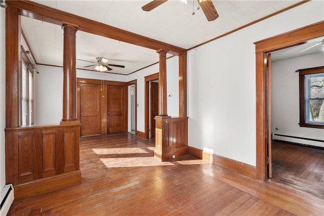 interior space with ornate columns, wood-type flooring, and a baseboard radiator